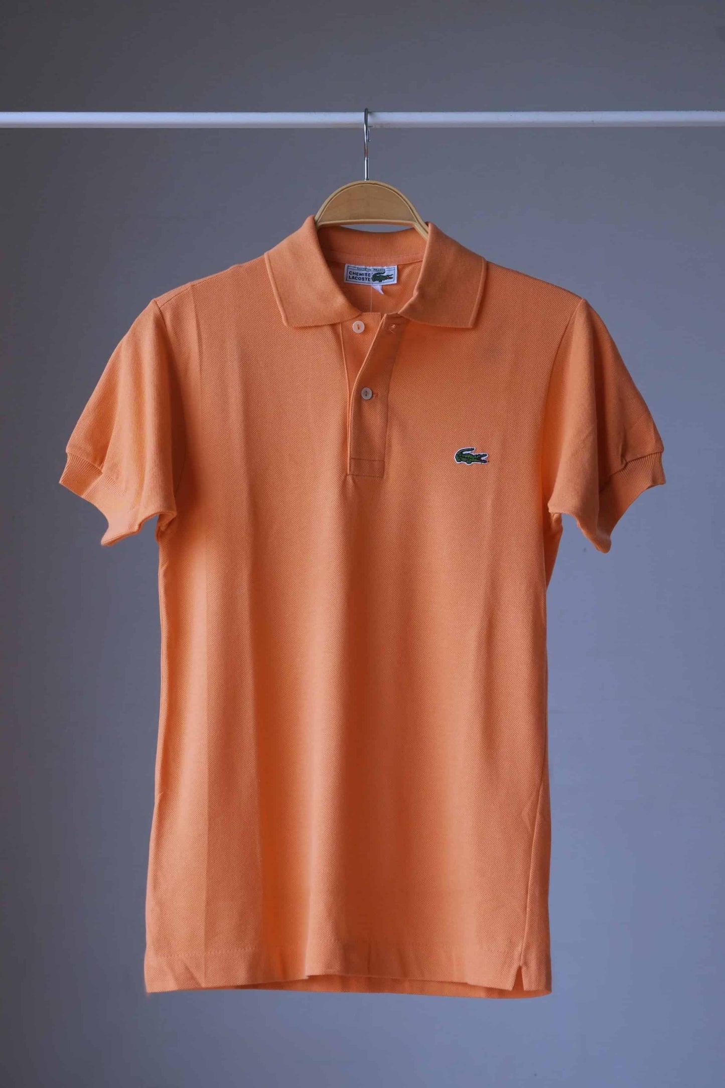 LACOSTE Retro Shirt in peach orange color on hanger