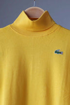 close up of yellow LACOSTE Turtleneck on hanger