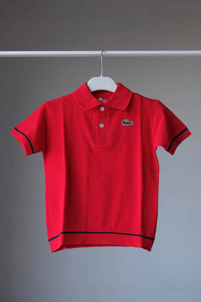 LACOSTE Vintage Kids Polo on hanger in red with a navy line on sleeves and hem