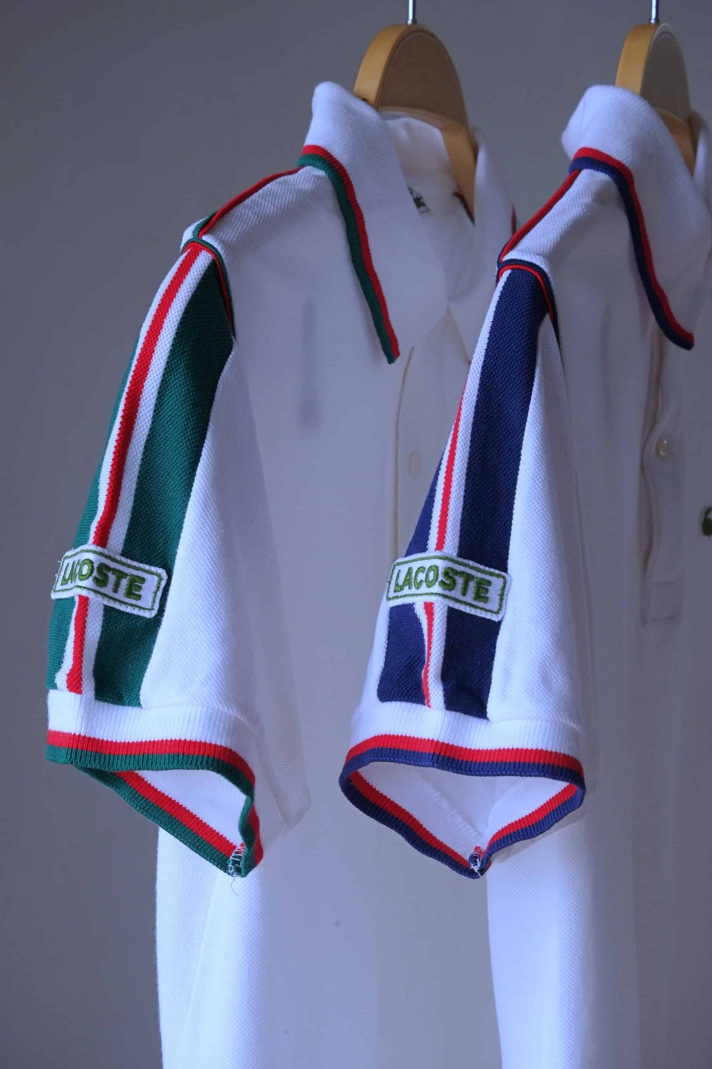 Lacoste vintage shirt in white with green stripes, and in white with navy stripes on hanger