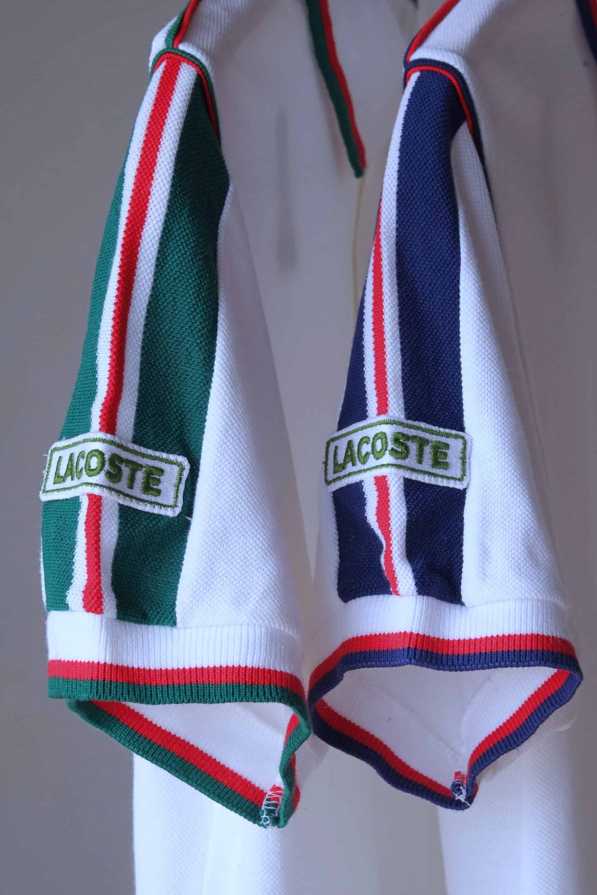 Lacoste vintage shirt in white and green stripes and white with navy stripes, slose up of sleeves