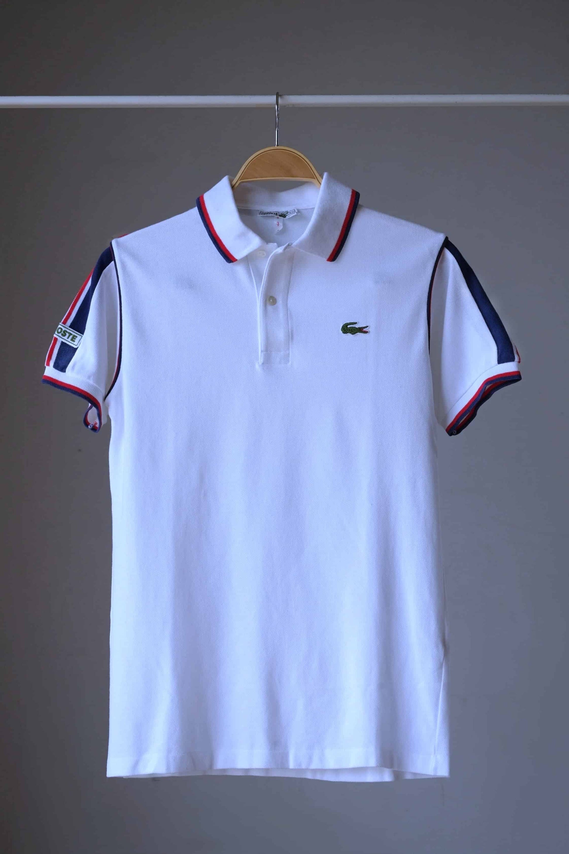 Lacoste vintage shirt in white and navy stripes on hanger