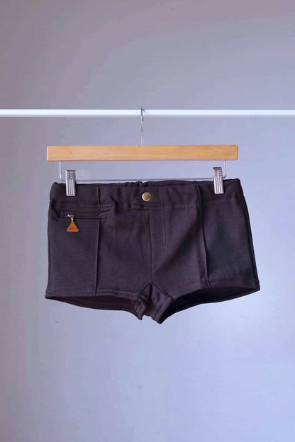 Brown Vintage 60s Lahco Mataro model swim trunks on hanger, showing structured waistband and minimalist design.