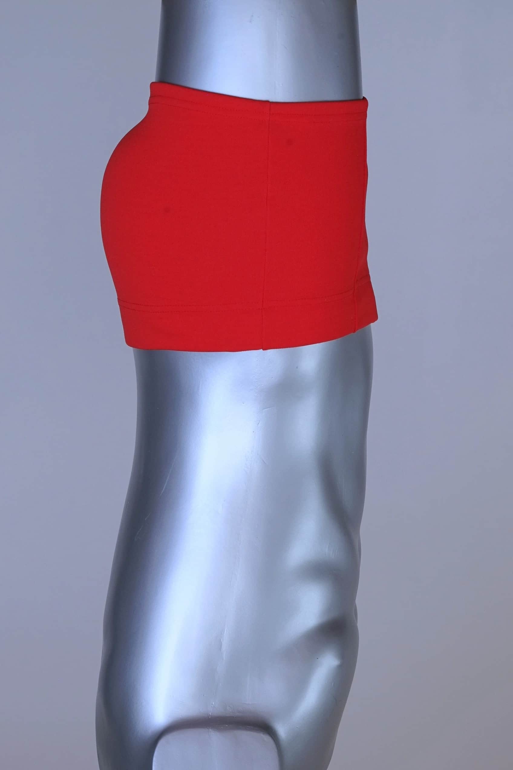 Side view of red Lahco vintage 60s swim trunks (Mataro model) on silver mannequin, showing zip pocket and snap waistband.