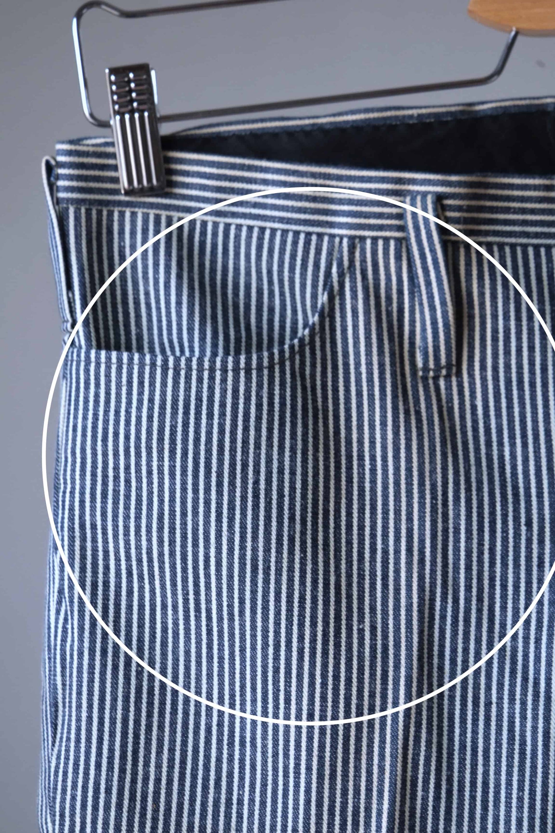 Close view of LEE 60's Vintage Tapered Slim Pants black and white stripes, with circle showing a stain