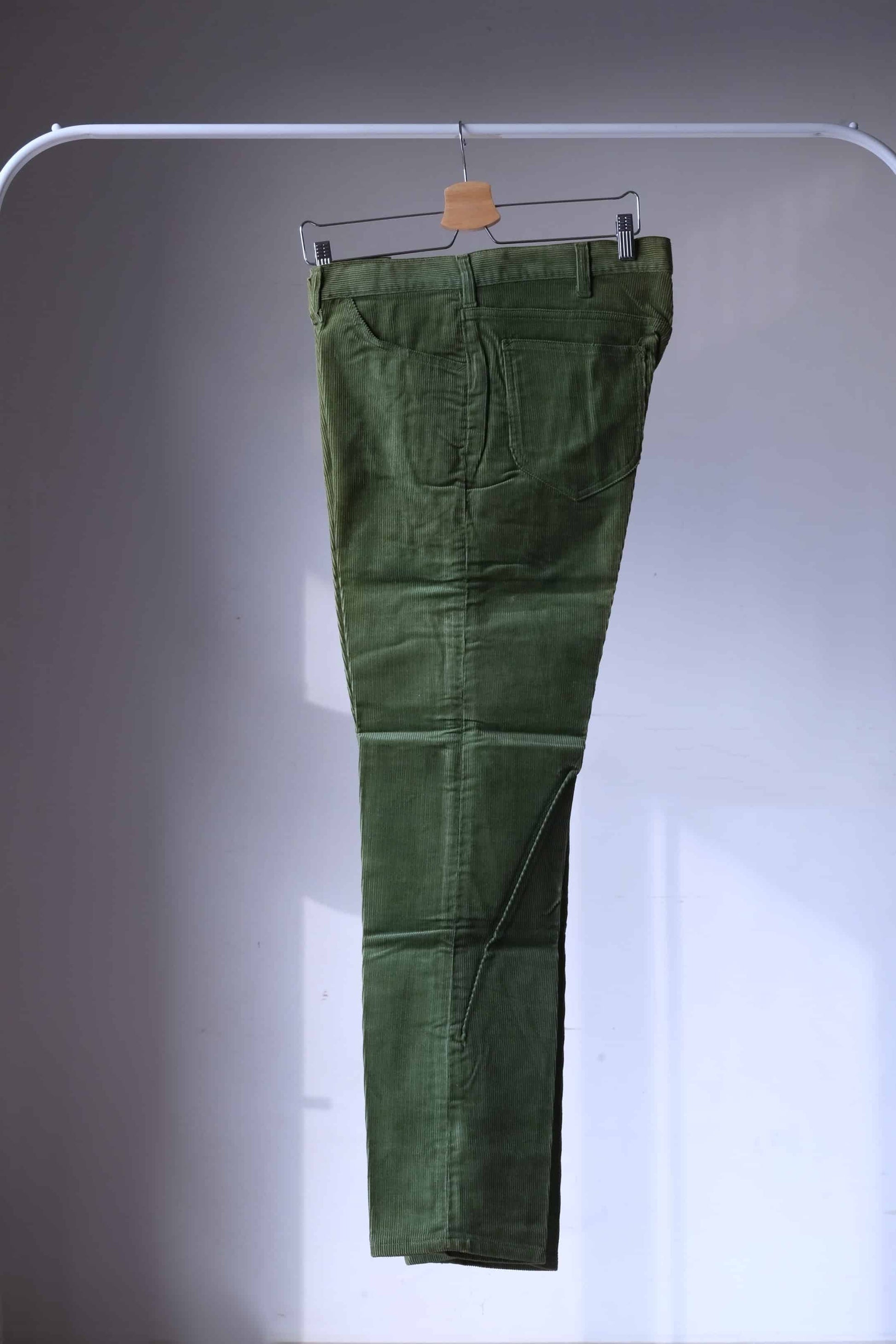 LEE Corduoroy Pants in olive green photgraphed on hanger from the side