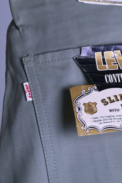 Extreme close-up of the white Big E red tab on the back pocket of the 1960s Levi's Continental trousers (sage color).