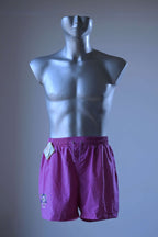 Front view of a pair of magenta vintage Löffler shorts with a small logo on the left leg, displayed on a mannequin.