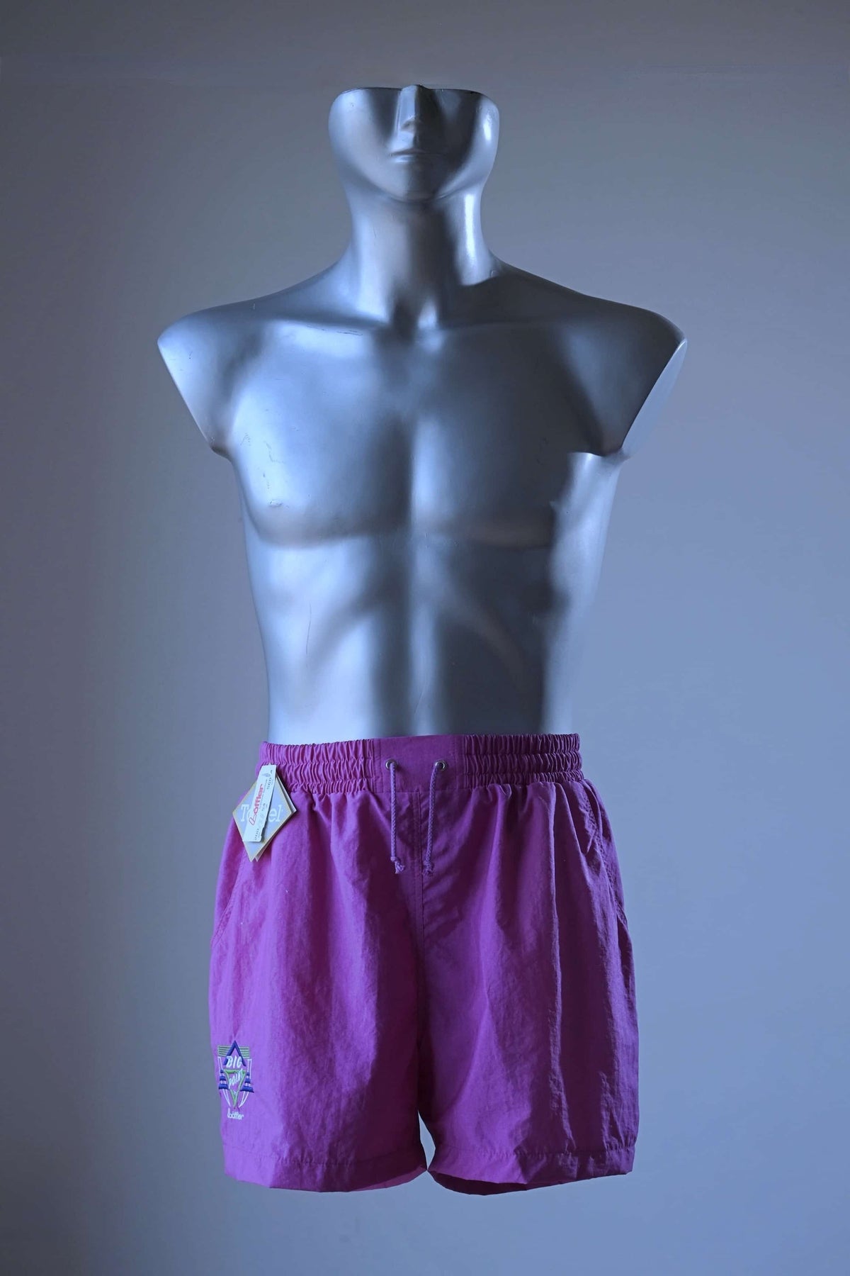 Front view of a pair of magenta vintage Löffler shorts with a small logo on the left leg, displayed on a mannequin.