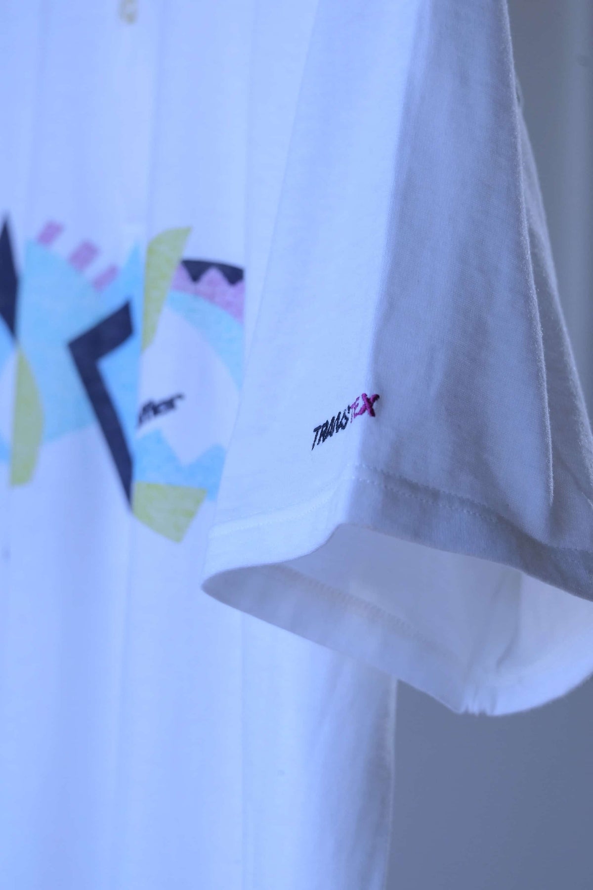 Short sleeve of the vintage Löffler polo with an embroidered Transtex logo near the hem