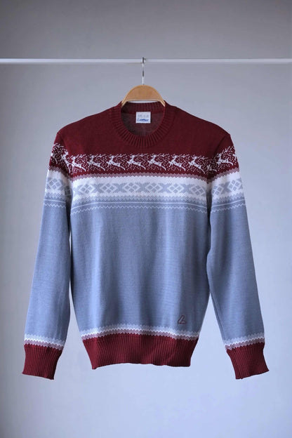 Löffler brand burgundy and gray wool blend sweater featuring a white Nordic pattern with reindeer and snowflake motifs, hanging on a wooden hanger against a plain background.