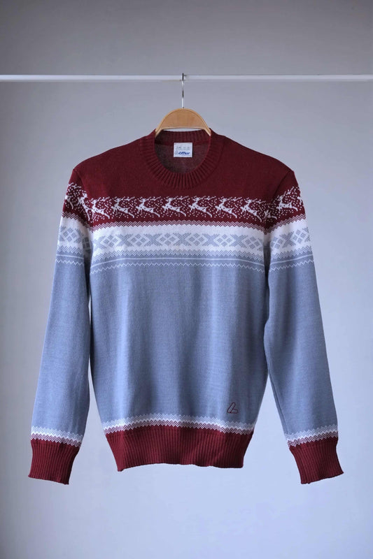 Löffler brand burgundy and gray wool blend sweater featuring a white Nordic pattern with reindeer and snowflake motifs, hanging on a wooden hanger against a plain background.