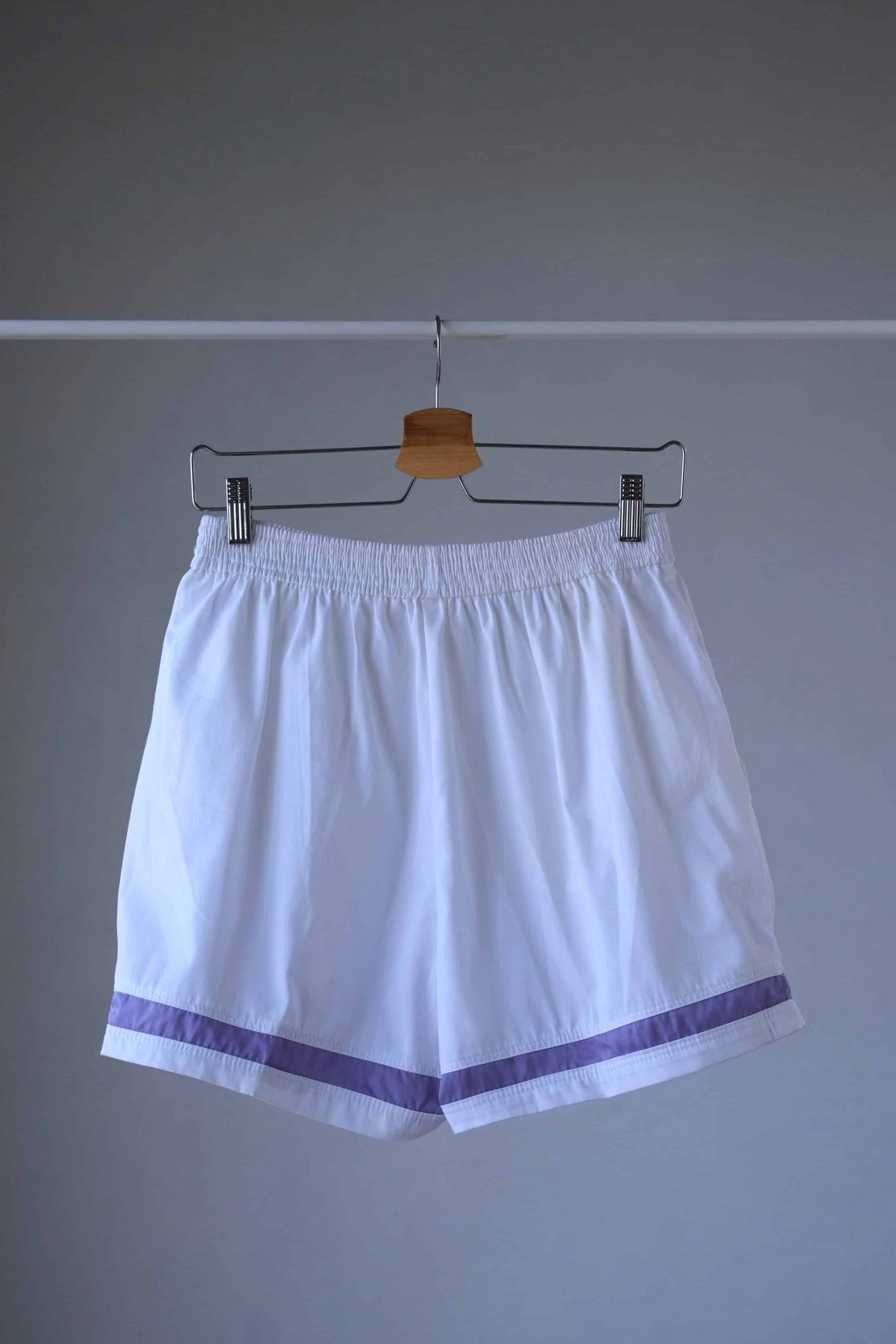 White and purple LÖFFLER Vintage Tennis Shorts shot from the back