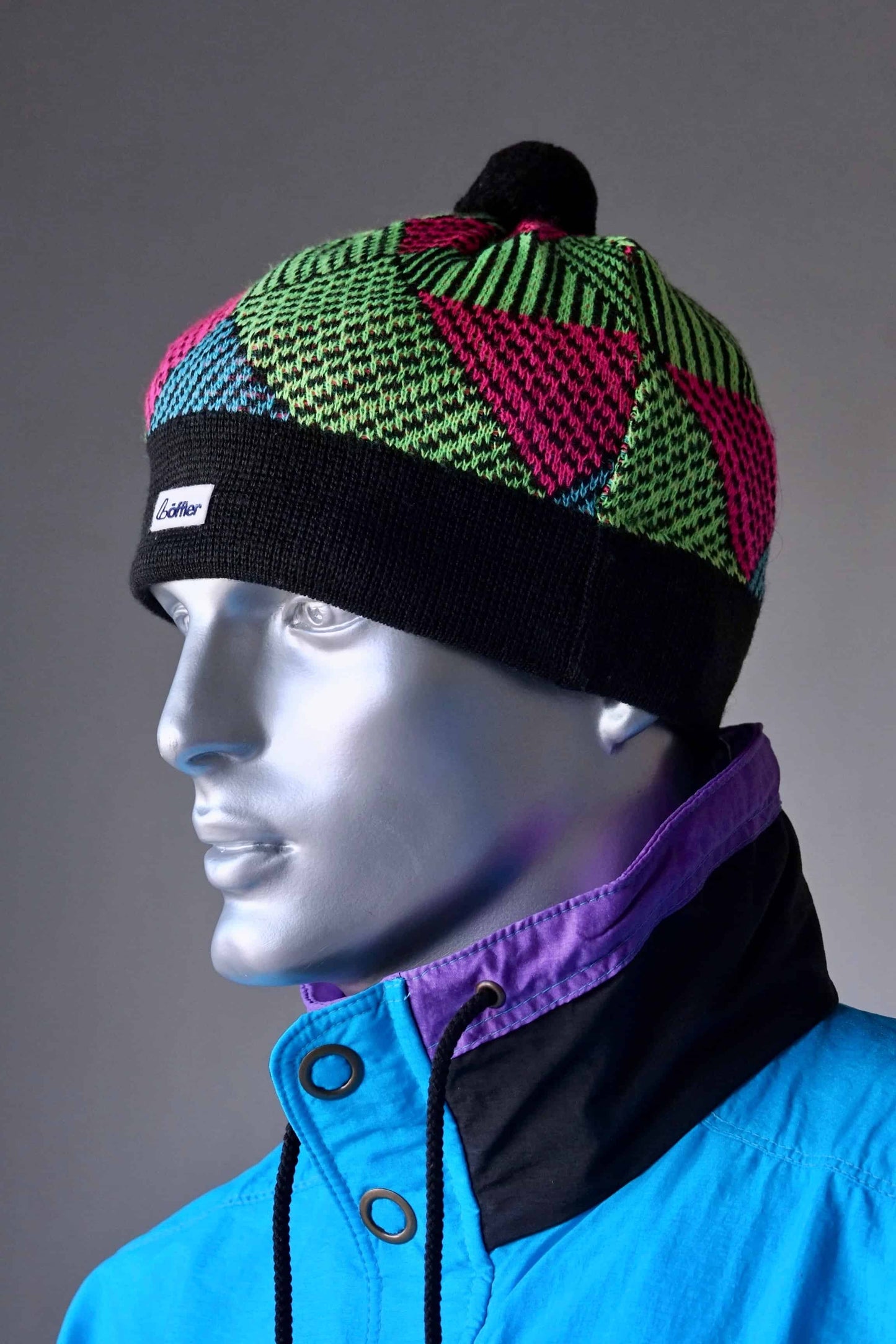 LÖFFLER 90's Ski Beanie black with neon green and pink on mannequin