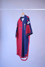 Side-angle view of the red and navy blue football jersey hanging on a wooden hanger, showing the fit and sleeve construction.