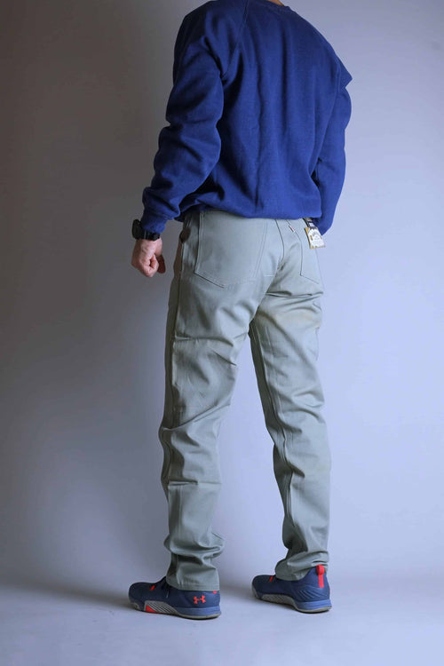 Back-side view of a model wearing the Deadstock Levi's Continental Trousers, showcasing the slim rear pocket placement and the slightly visible original tags.