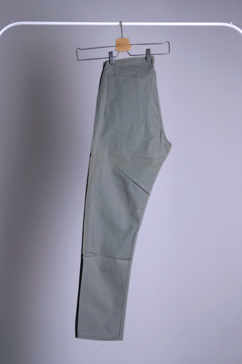 Side view of the Levi's Continental Slim Fit Trousers hanging, showing the tailored, trim silhouette.