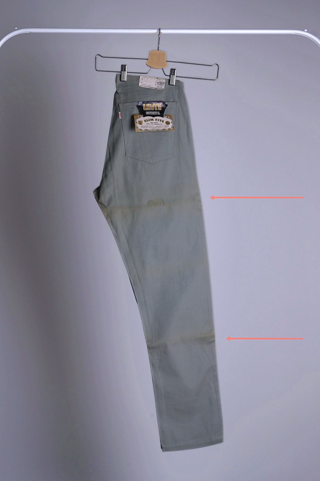 Side view of the Deadstock Levi's Continental chinos with orange arrows pointing to the areas with historic folding marks and discoloration from storage.