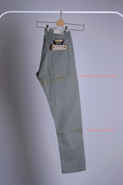 Side view of the Deadstock Levi's Continental chinos with orange arrows pointing to the areas with historic folding marks and discoloration from storage.