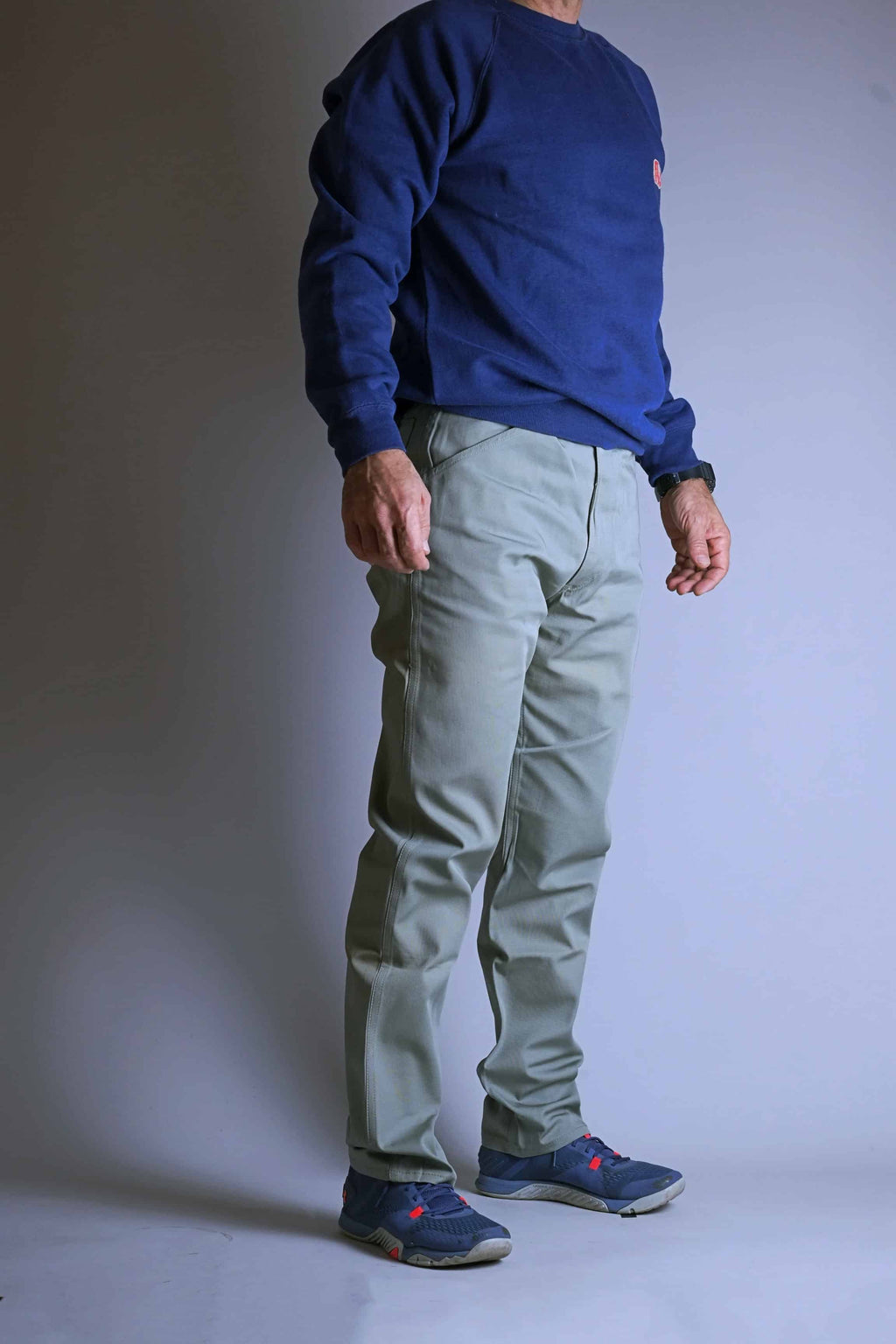 Side view of a model wearing the 1960s Deadstock Levi's Continental Slim Fit Chinos (sage green), showing the tailored fit from hip to ankle.