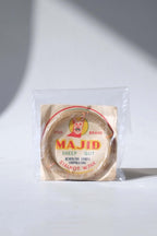 Vintage pre-1971 Majid Dog Brand organic sheep gut racket strings, sealed inside a protective clear collector's sleeve.