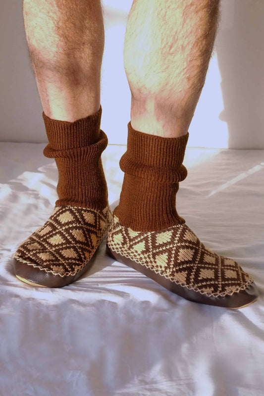 Patterned slipper socks in beige and brown worn on