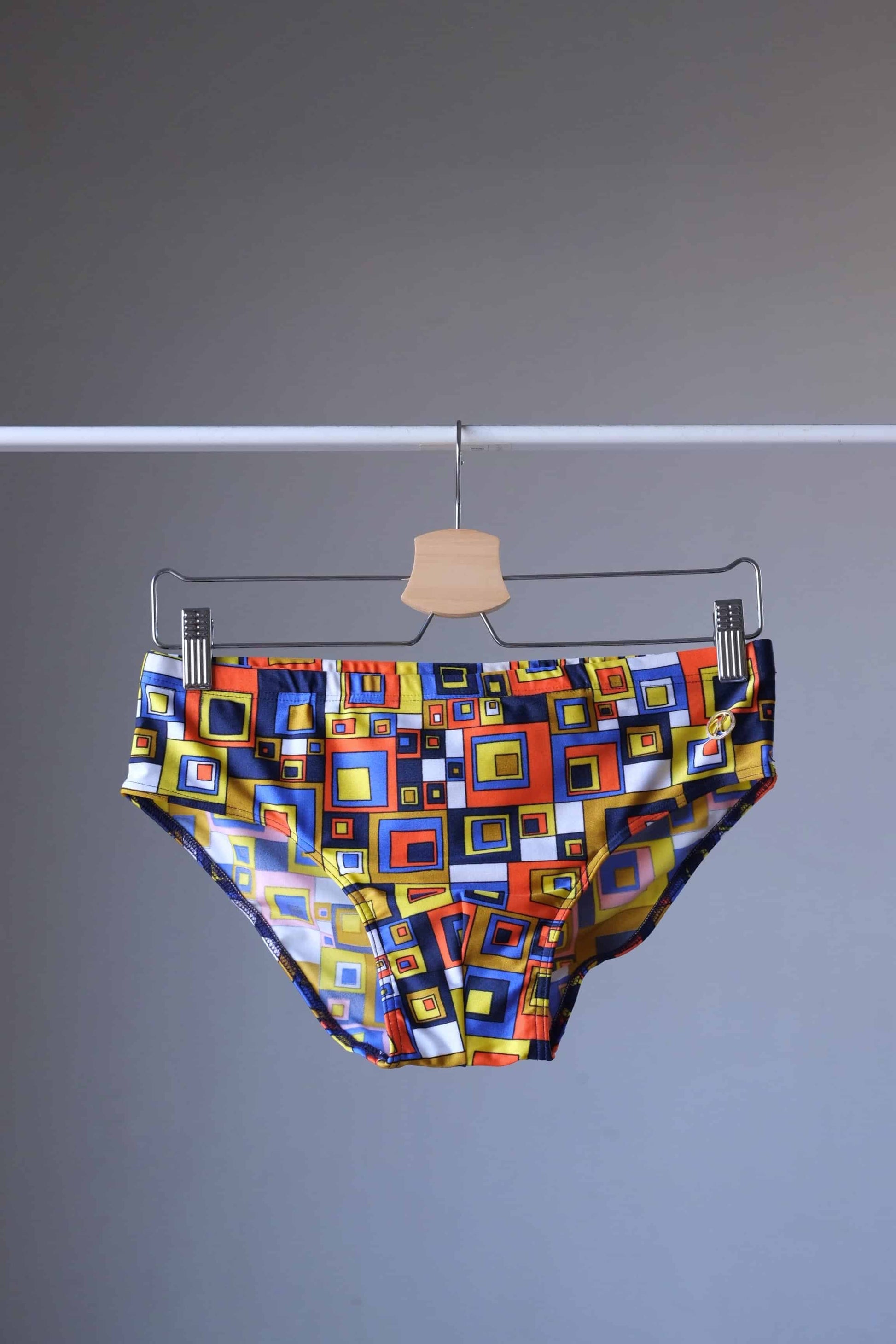 Vintage 80's Retro Geometric Square Swim Briefs in orange/yellow on hanger