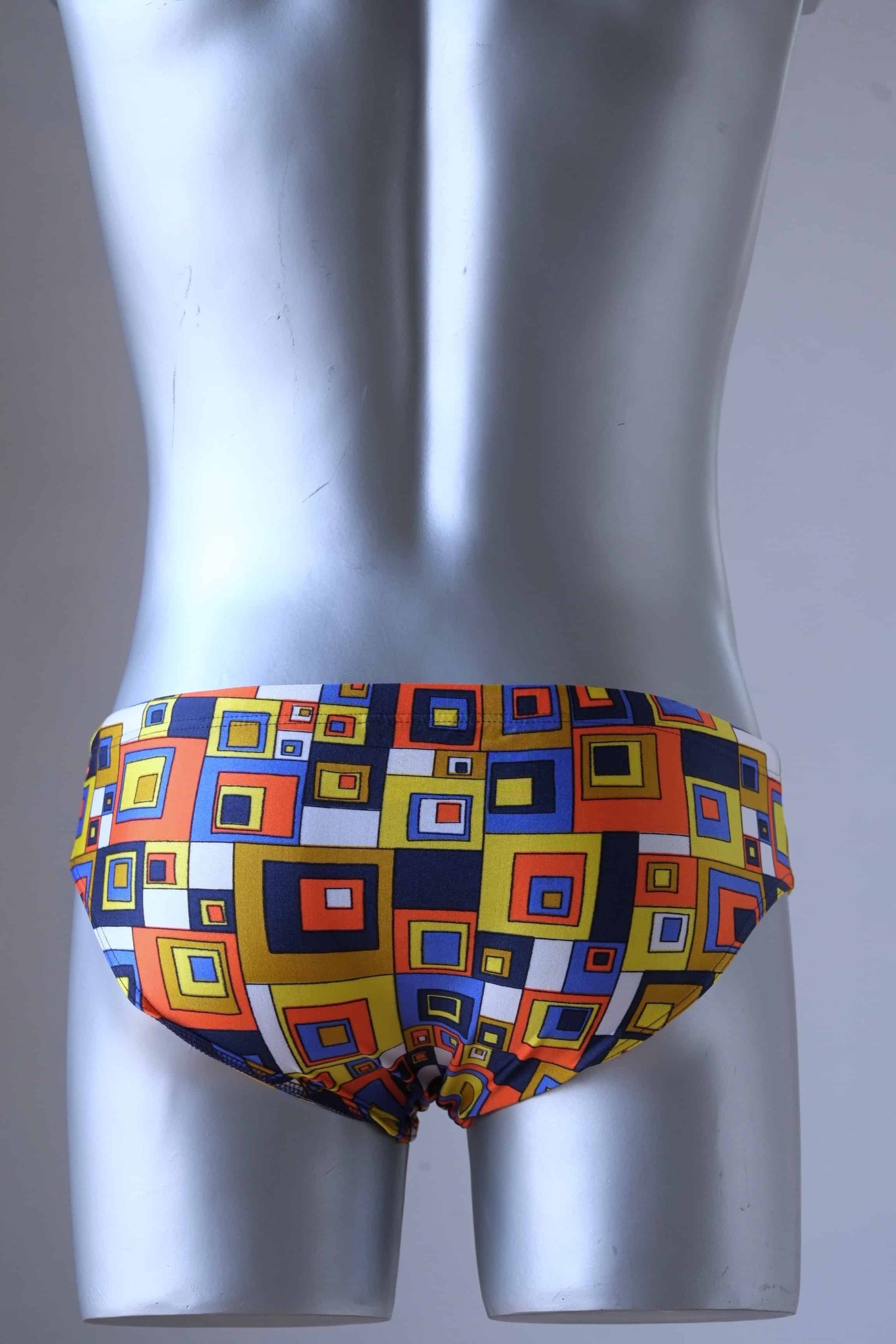 Vintage 80's Retro Geometric Square Swim Briefs in orange/yellow on mannequin from behind