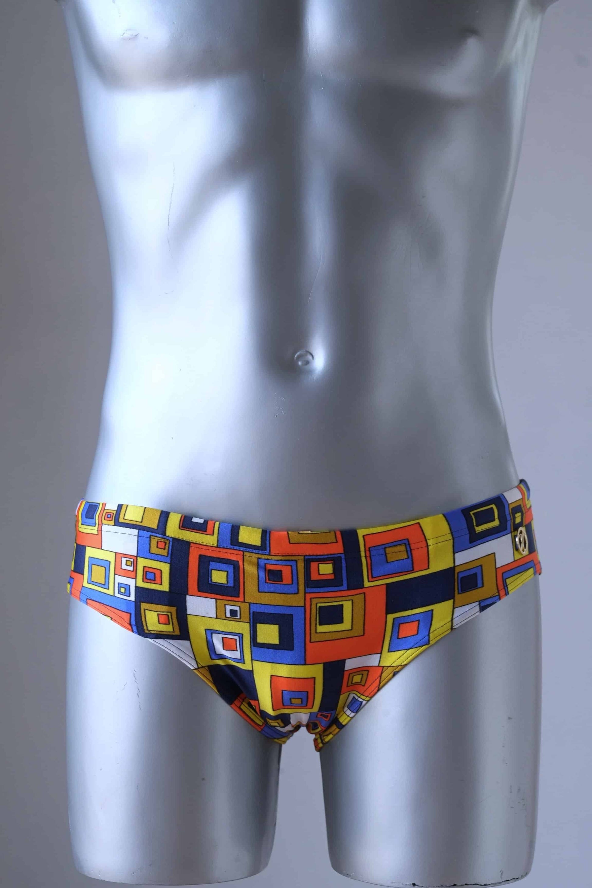 Vintage 80's Retro Geometric Square Swim Briefs in orange/yellow on mannequin