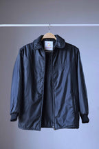 Open front view of the vintage Rangoon black 1970s ski jacket by Mossant Paris, revealing a clean interior lining and the woven brand label on the neck.