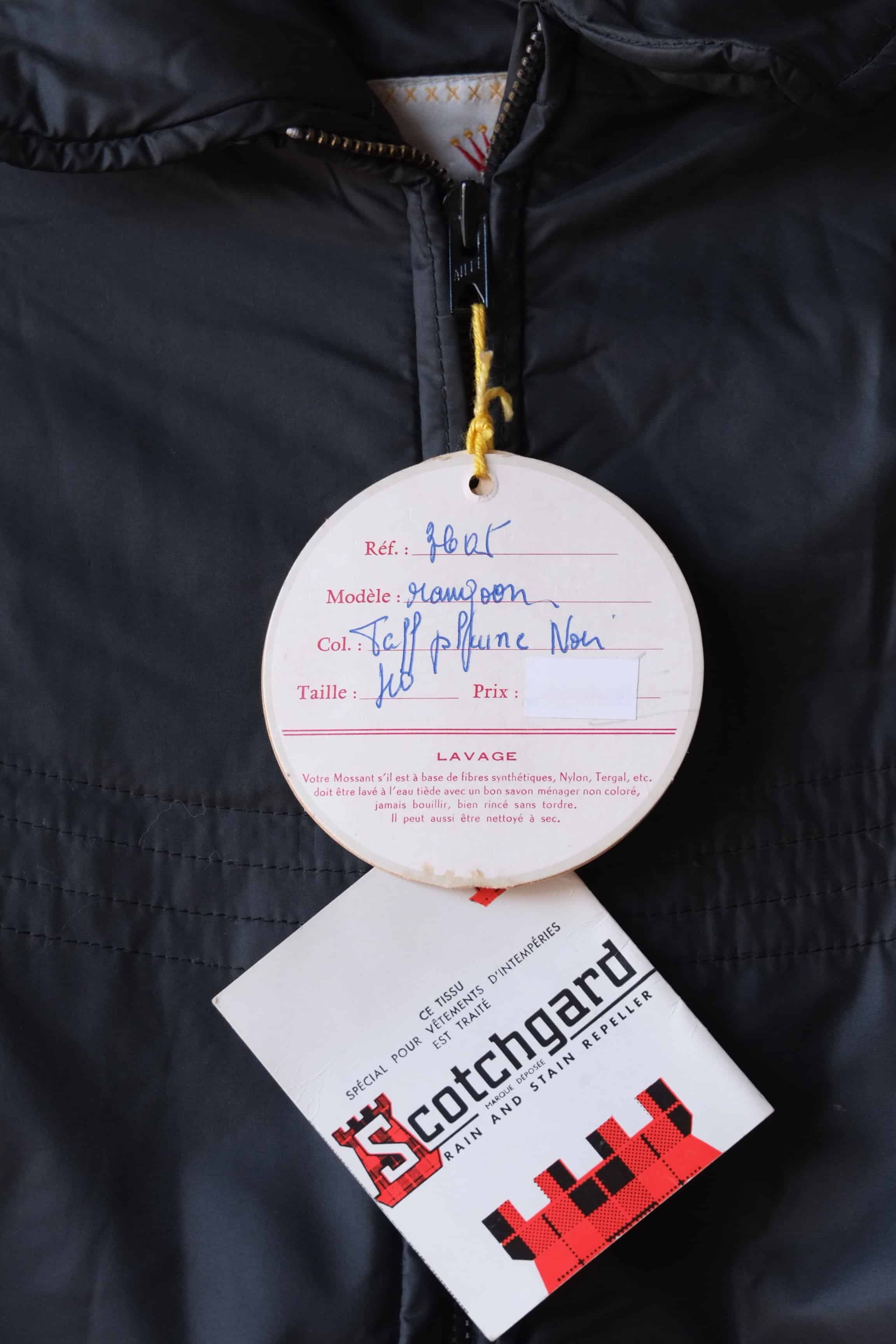 Close up of the original hangtags  of the Mossant jacket. The tag lists the model as "Rangoon," the color as "Noir" (Black), and the size as 40, with French care instructions printed below.