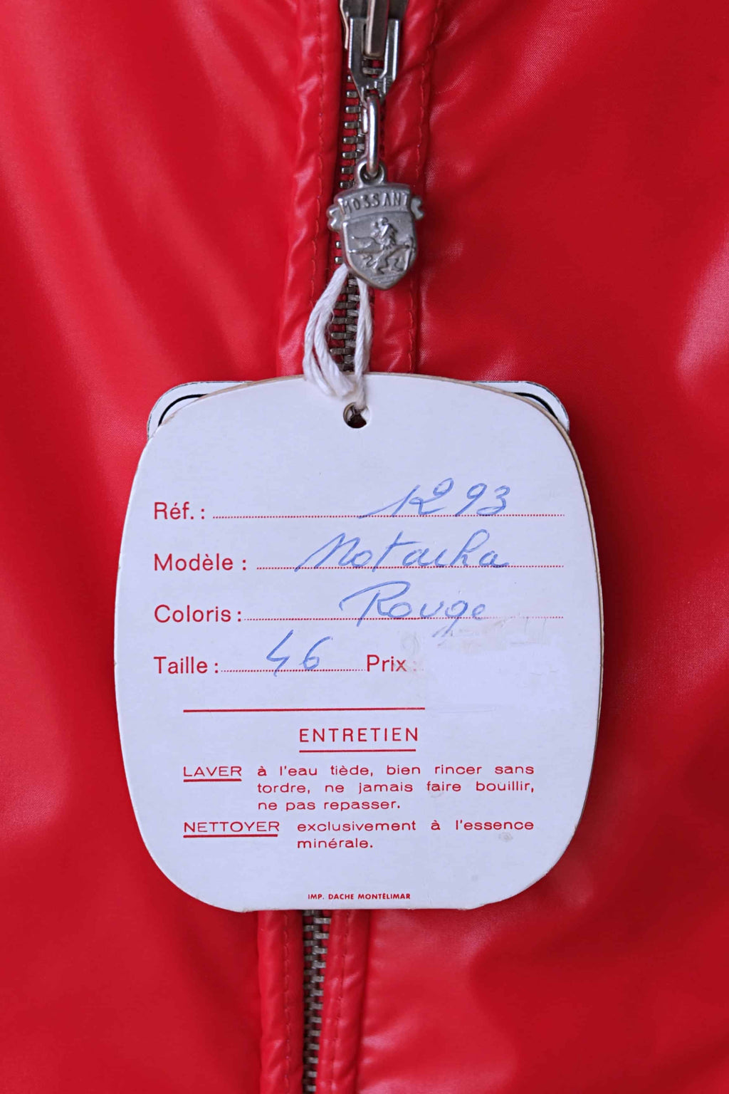 The original paper manufacturer's tag attached to the red Mossant jacket. The tag lists the model as "Natacha," the color as "Rouge" (Red), and the size as 46, with French care instructions printed below.