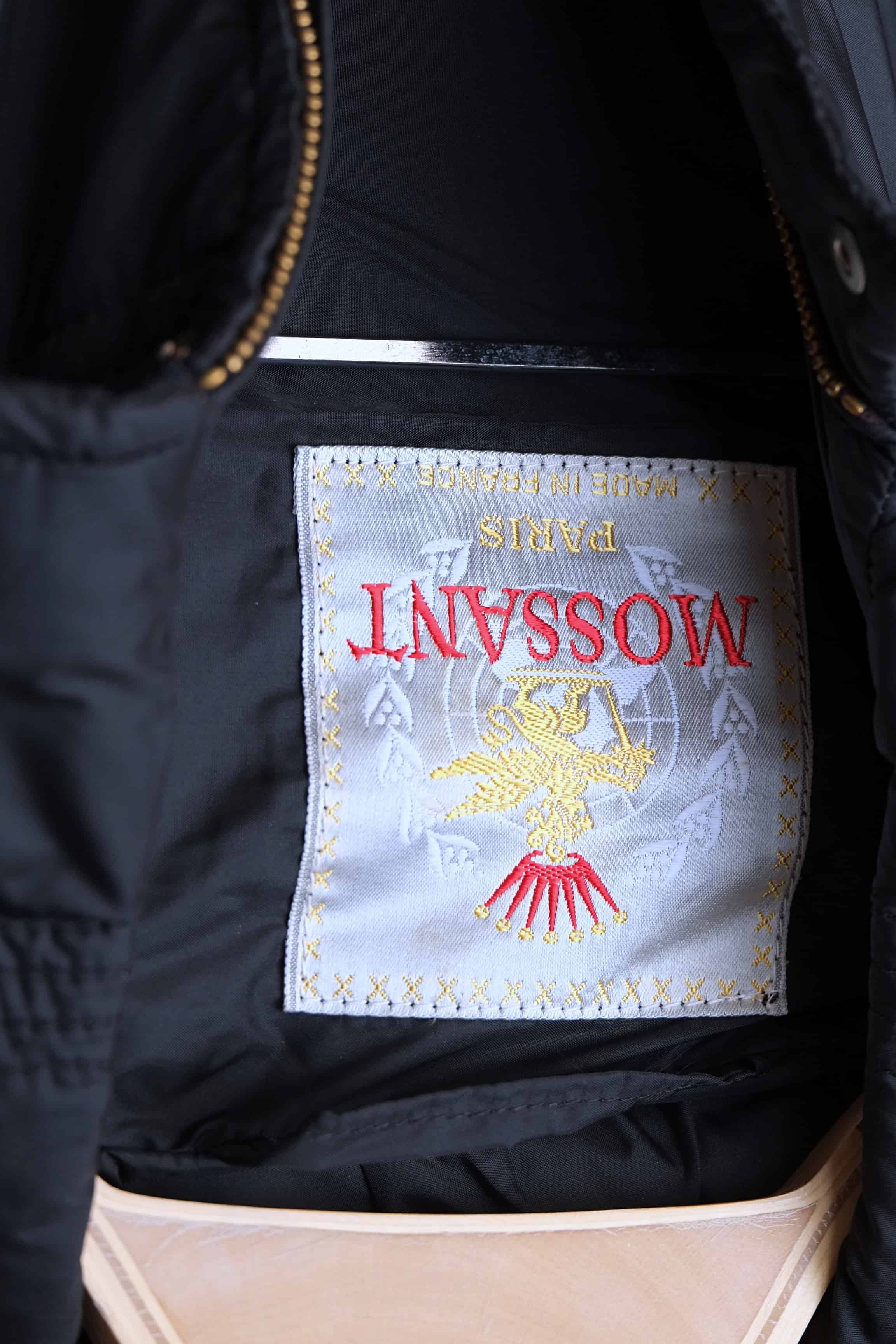 A white woven vintage neck label for Mossant Paris, featuring a gold crest with a red crown and "Made in France" text in gold.