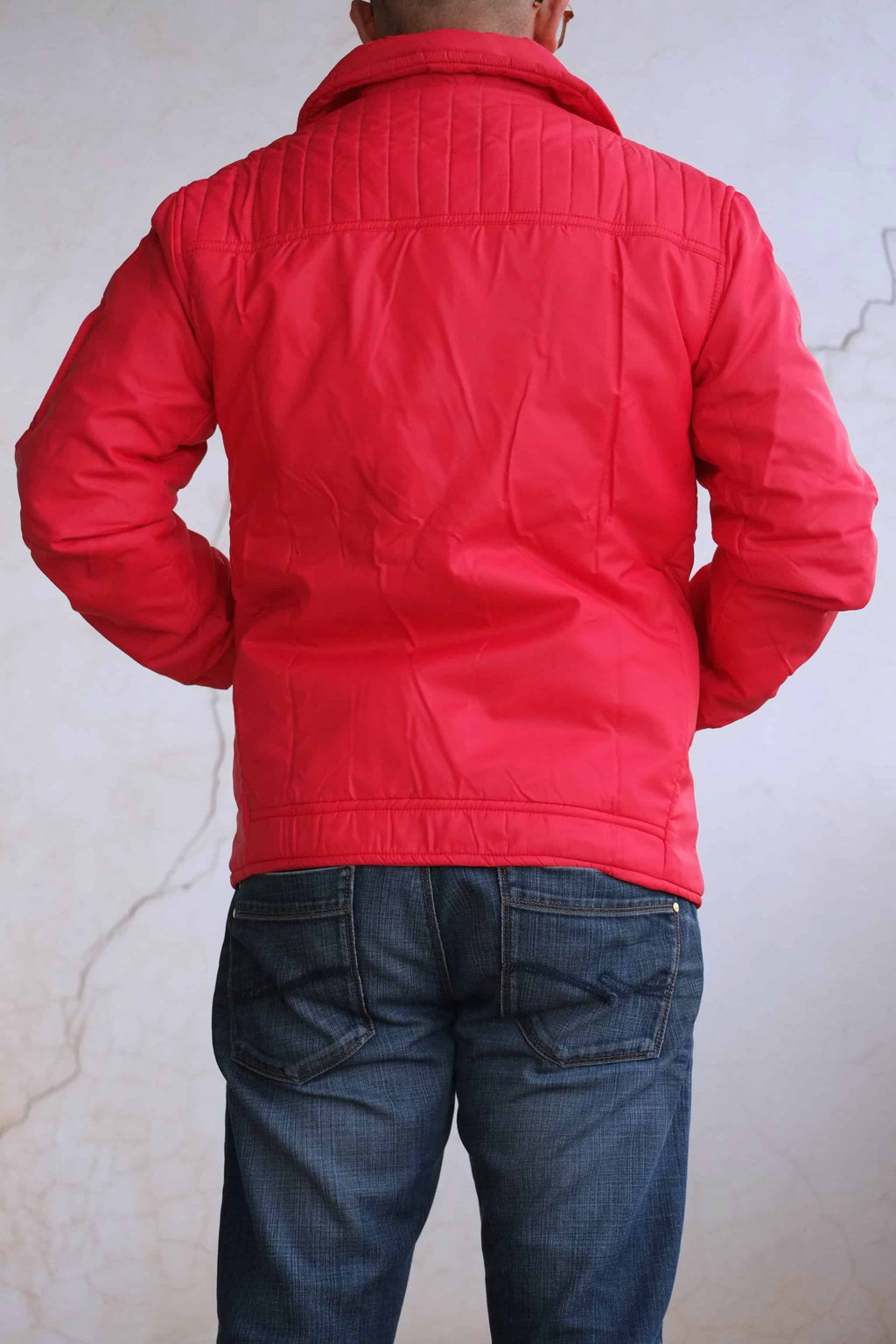 Rear view of the jacket on a model, showcasing the large quilted panel across the upper back and shoulders and the elasticated waistband.