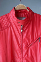 Detailed shot of the neckline with the collar snapped shut, highlighting the silver Mossant branded shield zipper pull and the inner vintage label.