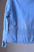 A detailed shot of the lower back of a sky-blue Mossant Aral vintage jacket, showing a wide band of decorative smocked ribbing above the hem.