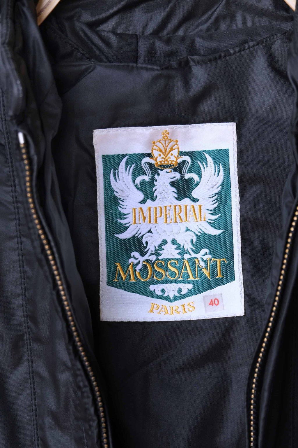 Close-up of the Imperial Mossant Paris woven inner label featuring a white eagle crest on a green background and size 40 tag.