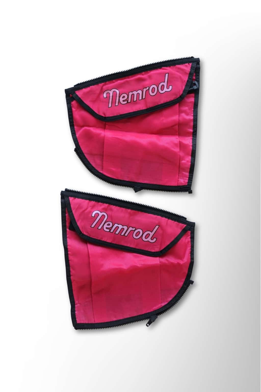 A pair of red pockets with flaps, against a white background, they have the brand Nemrod printed on them in white.