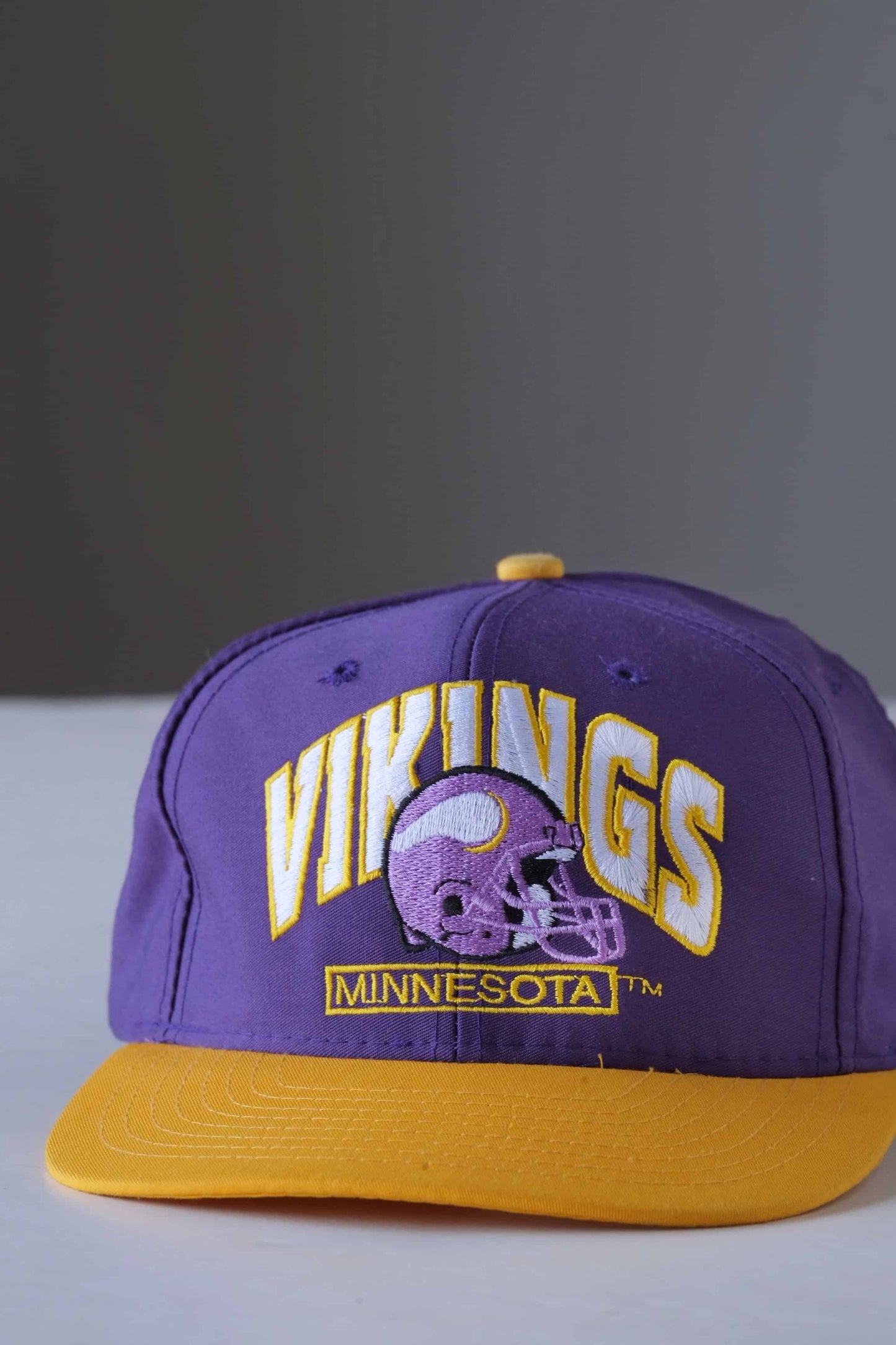 purple and yellow minnesota vikings nfl snapback hat on white background