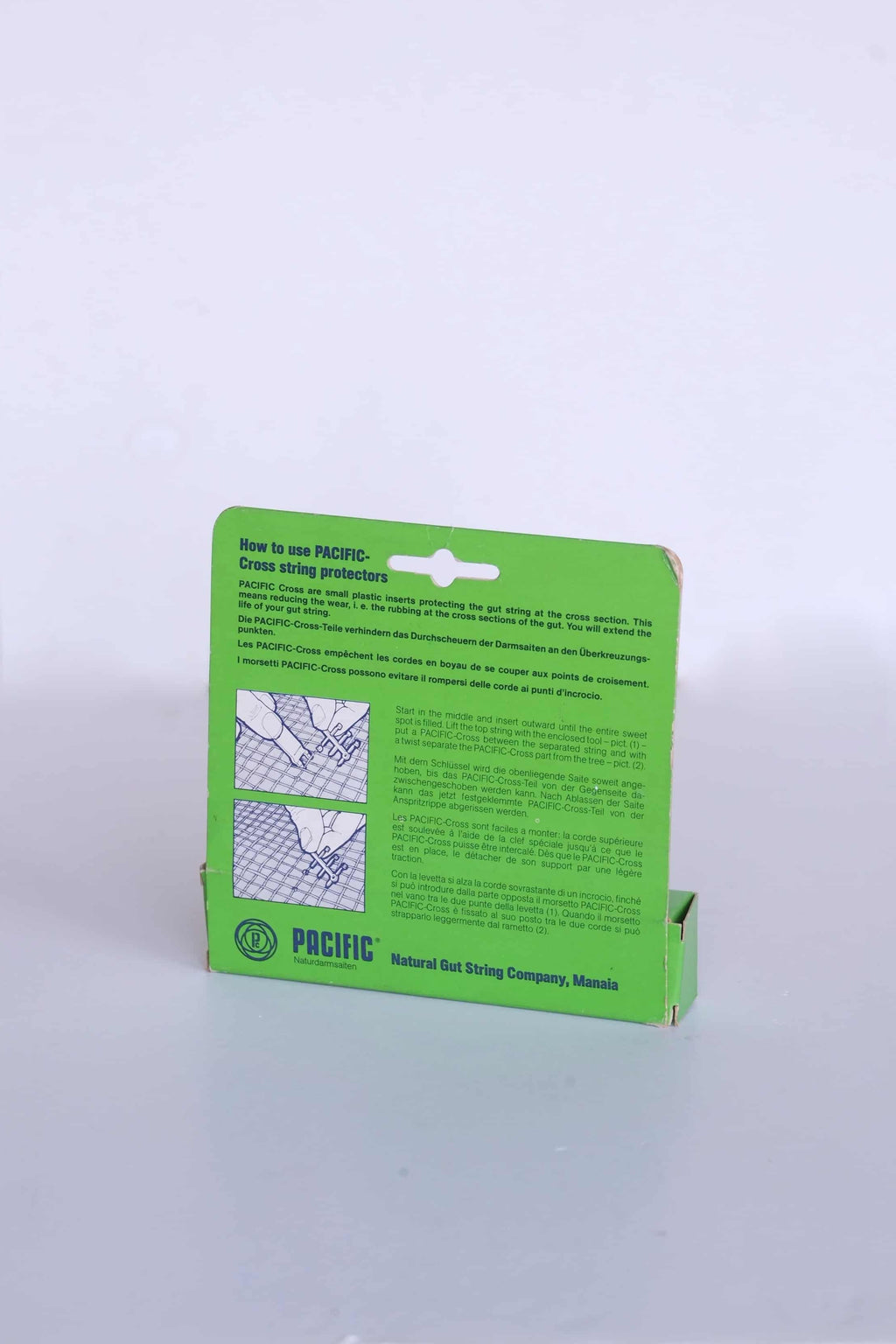 Back view of vintage Pacific Cross packaging, showing printed illustrated instructions for natural gut strings.