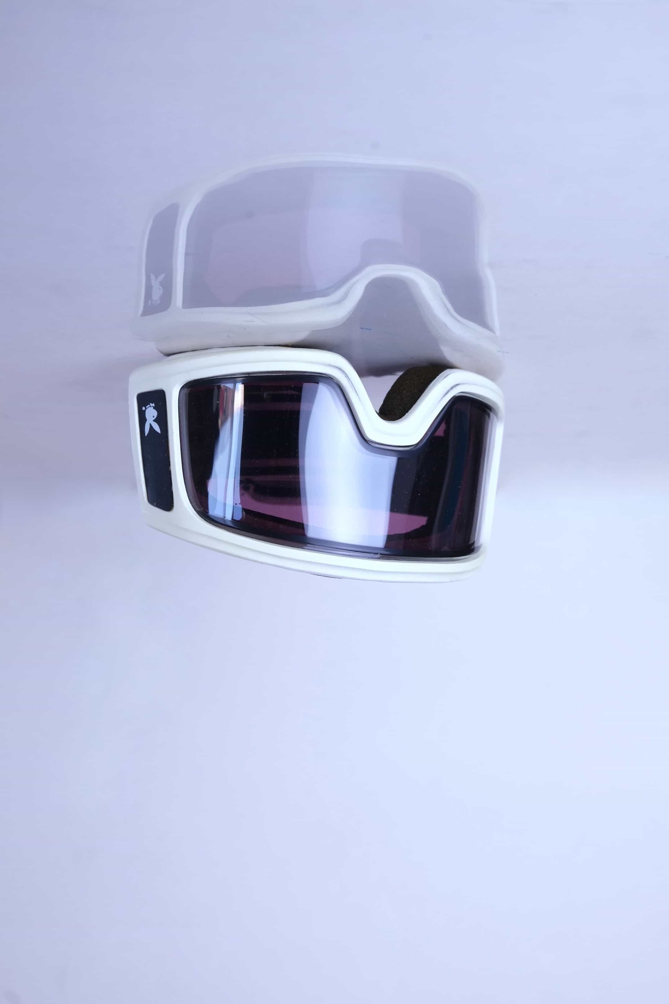 Angle. shot of the dark-tinted double shield lenses on the white 1980s Playboy frame.