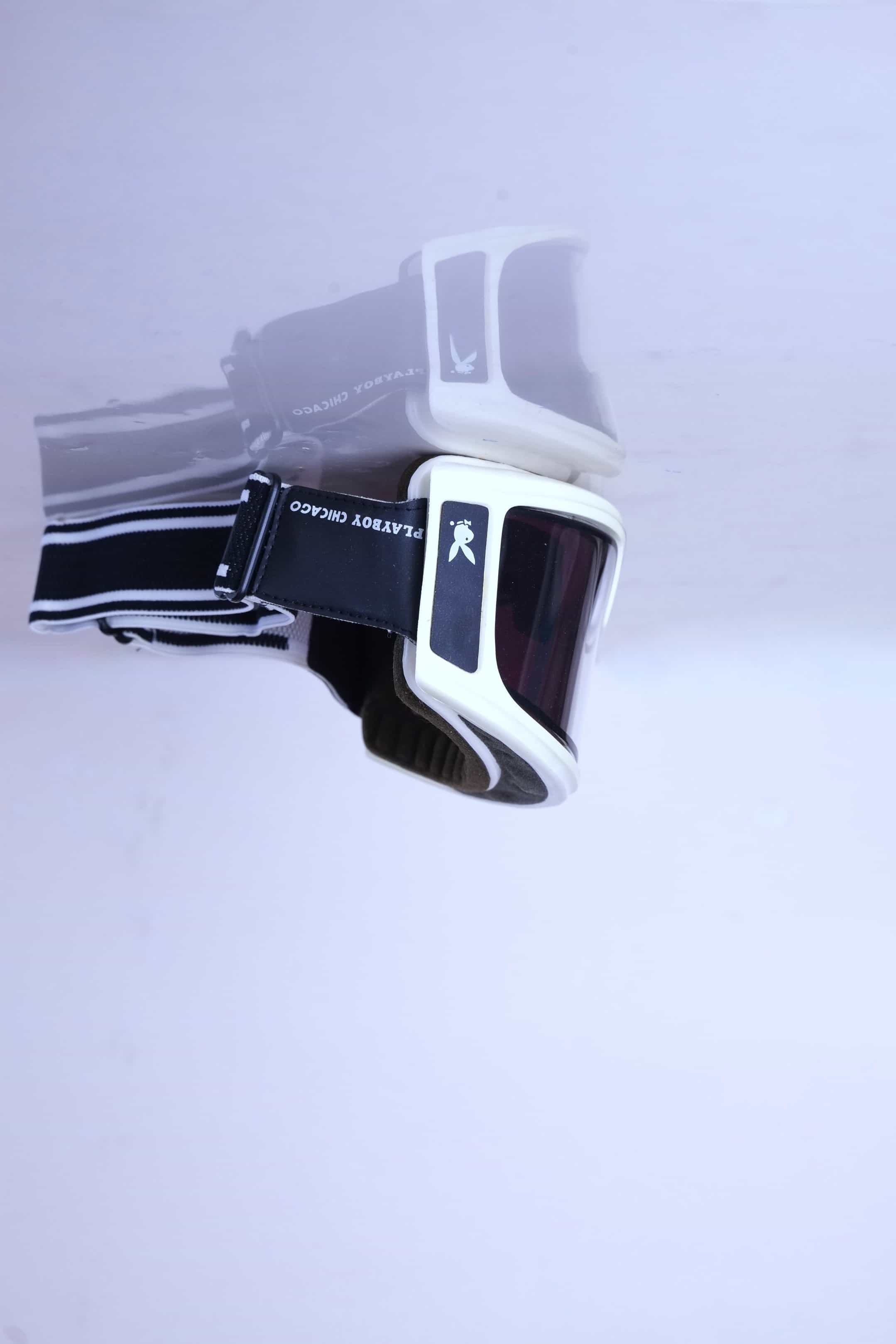 Side view of white Playboy Chicago ski goggles highlighting the rabbit head logo and intact interior foam.
