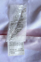 Close-up of the interior washing instructions tag, showing printed text in multiple languages and an attached lower label clearly listing "STYLE NO. 762299", the factory production code "0916 C1788166B0007995", and "TMXIM".