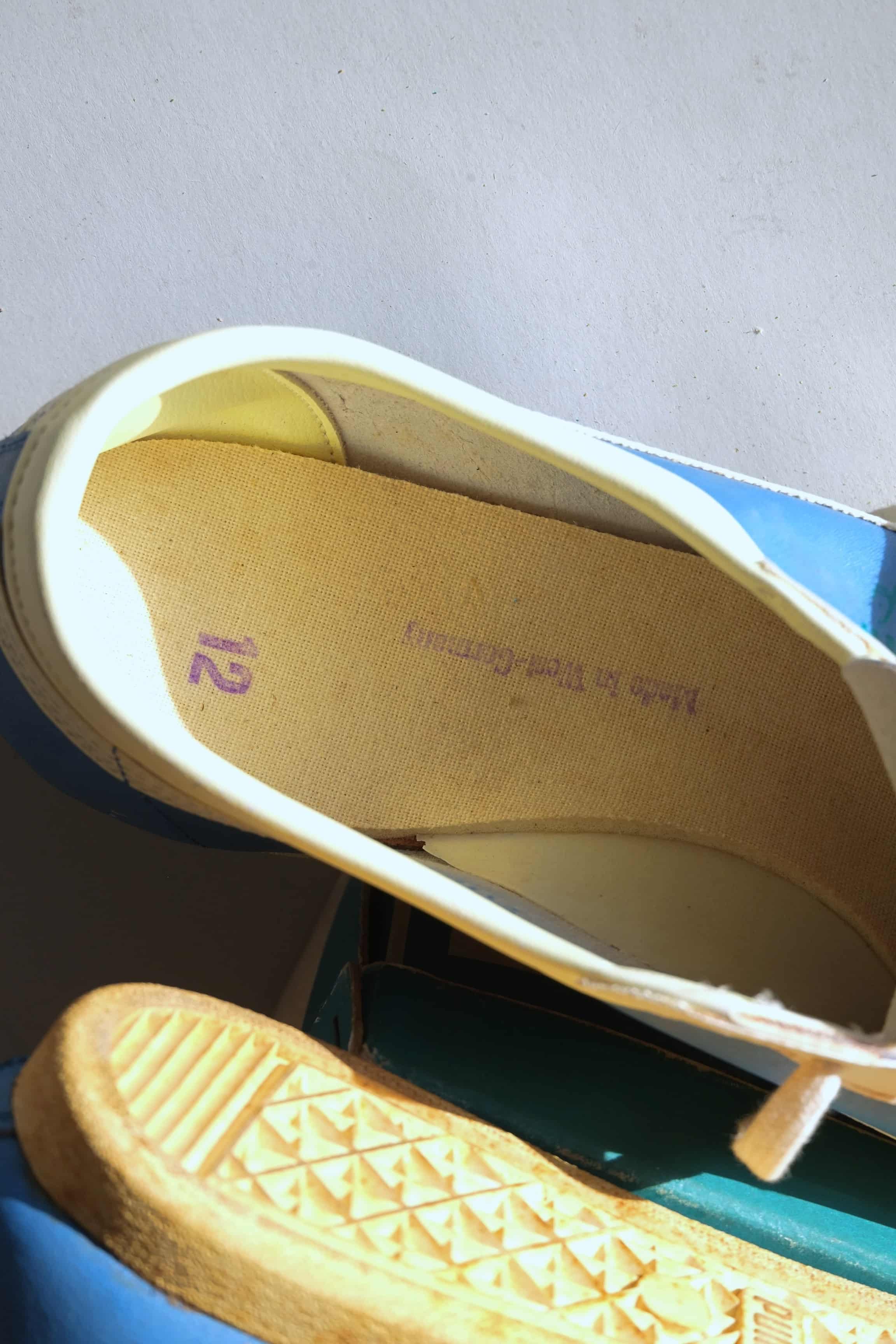 Interior insole view showing purple Made in West Germany and size 12 stamps inside vintage 1970s Puma Top Fit shoe.