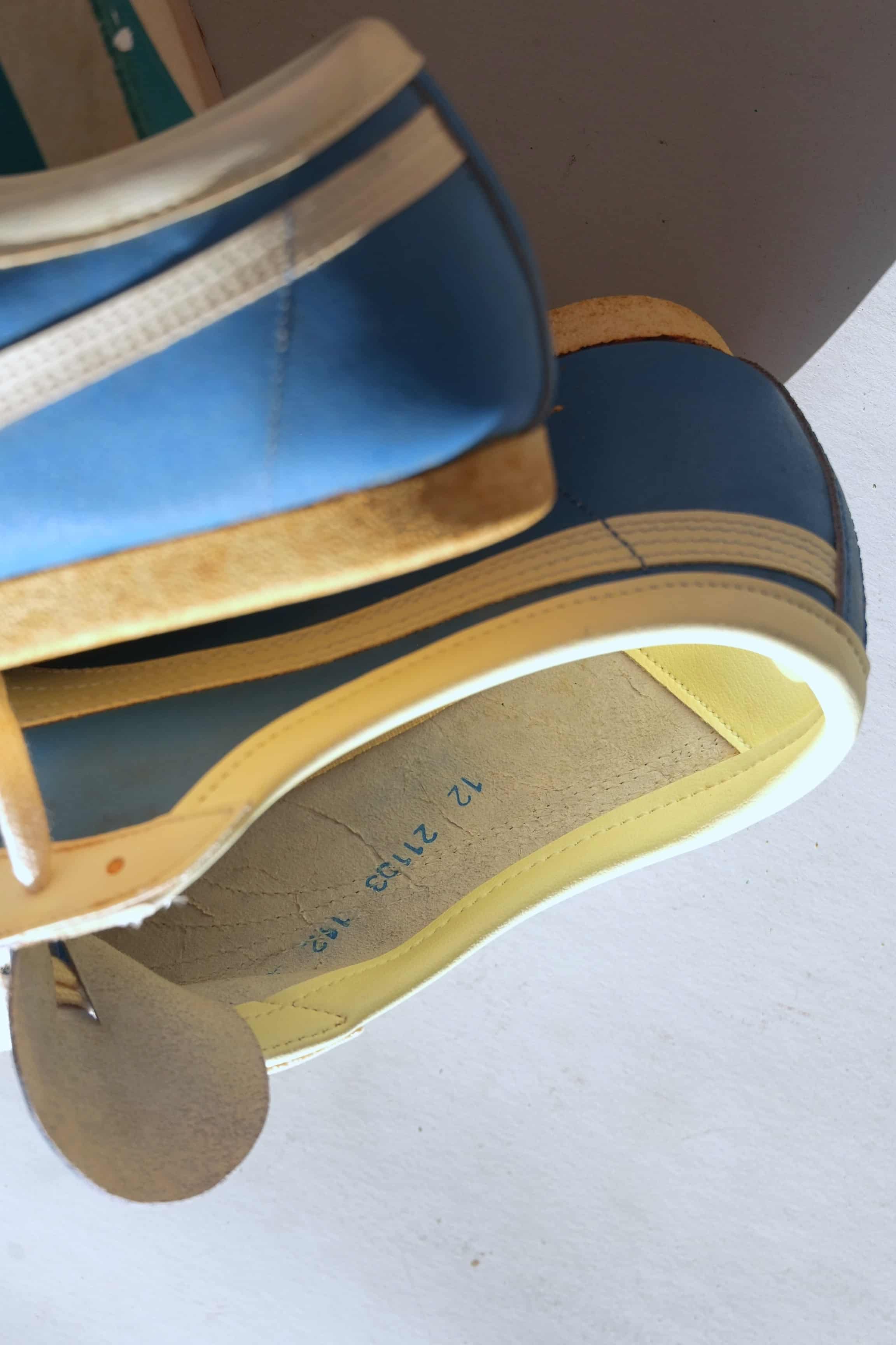 Inside heel lining of vintage Puma Top Fit sneaker displaying blue factory model code stamps 12 21103 112.