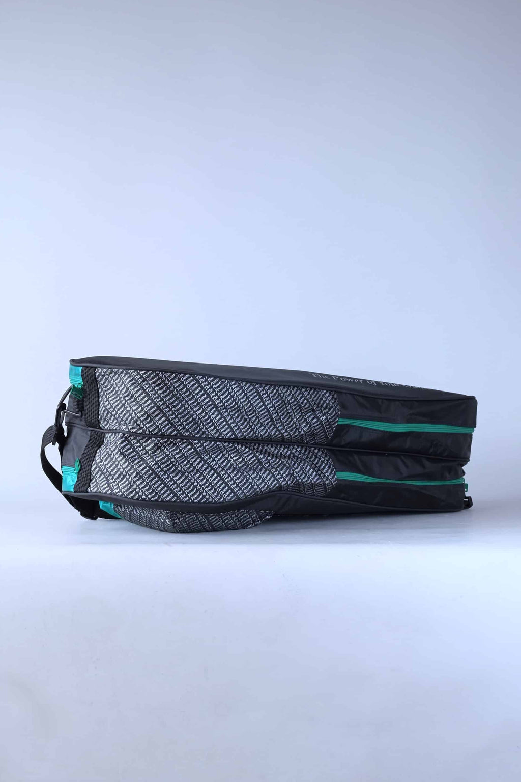 Underside view of the vintage Pacific tennis bag, showcasing the clean green and black synthetic base panels.