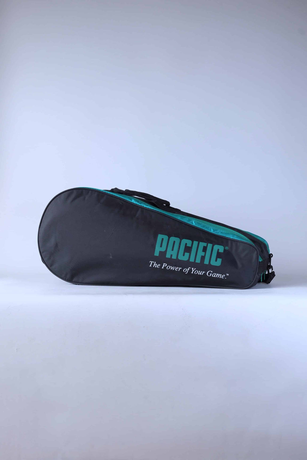 Side view of a vintage 1990 Pacific 6-racket thermal tennis bag in black, green, and white.