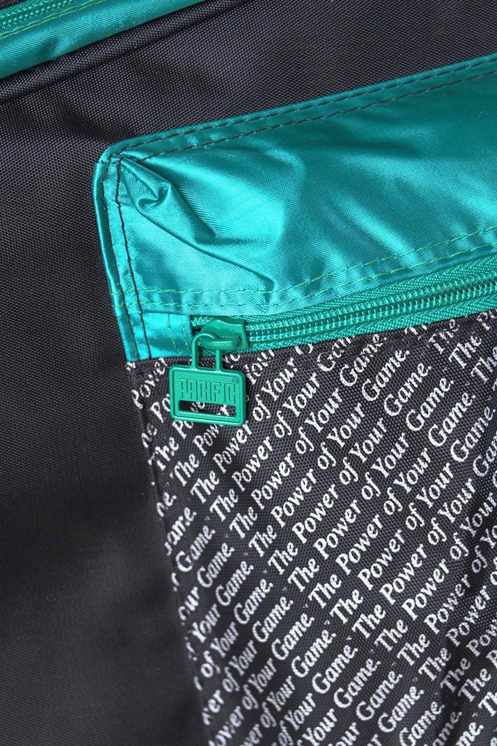 Close-up of the side accessory compartment zipper on the vintage Pacific multi-racket bag.