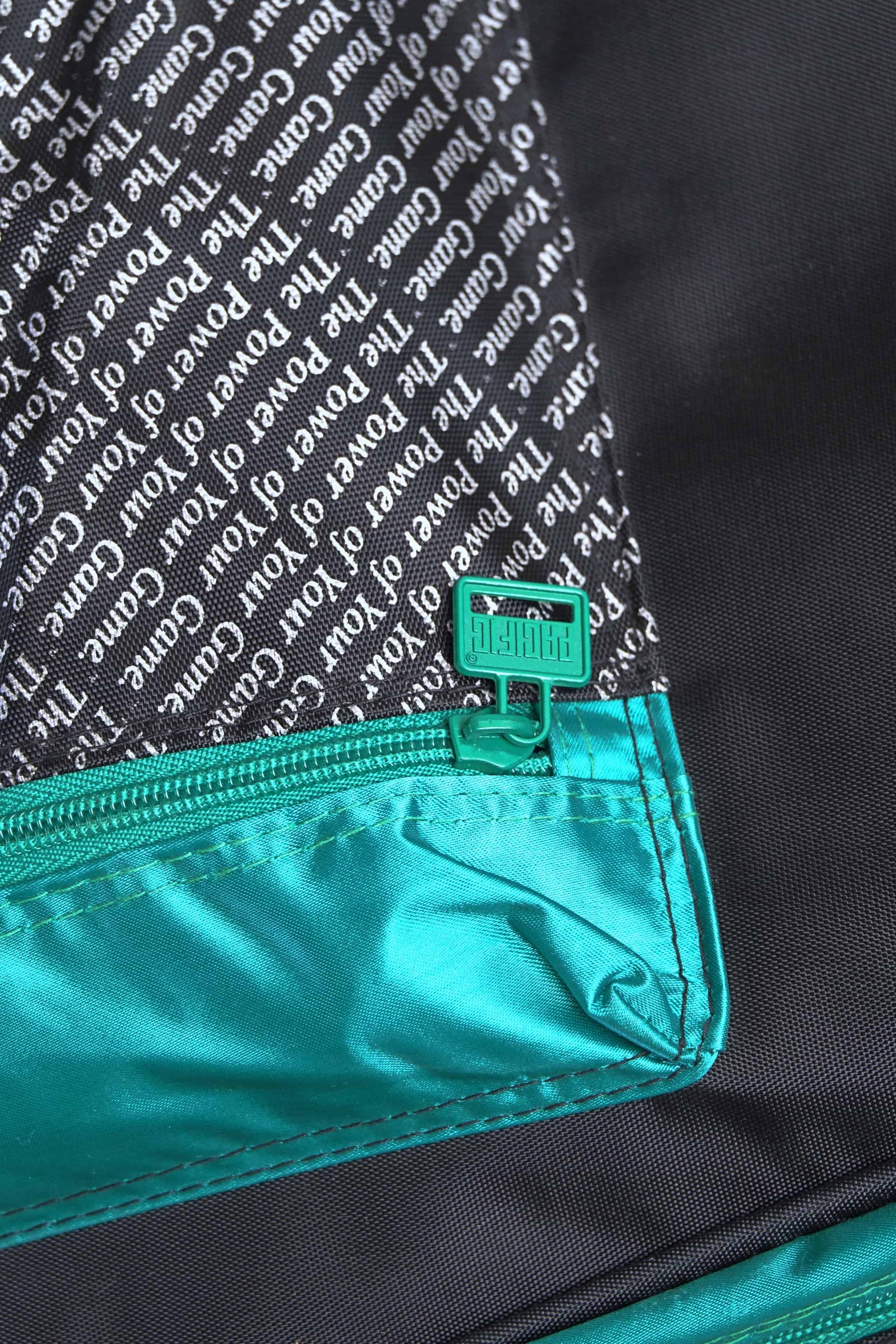 Close-up of the side accessory compartment zipper on the vintage Pacific multi-racket bag.