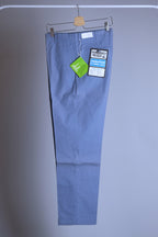 Side profile of a dusty blue pair of vintage Permanent Press tapered slacks showing the slim 70s silhouette and wrinkle-resistant fabric.